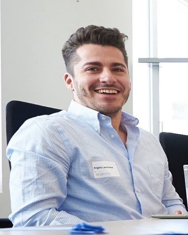 Angelo Lamonaca, smiling, at a meeting table.